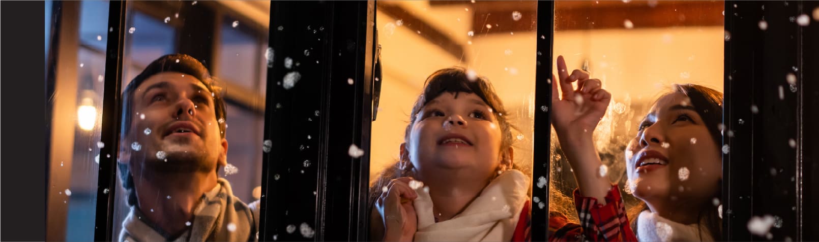 Family looking at snow out of window