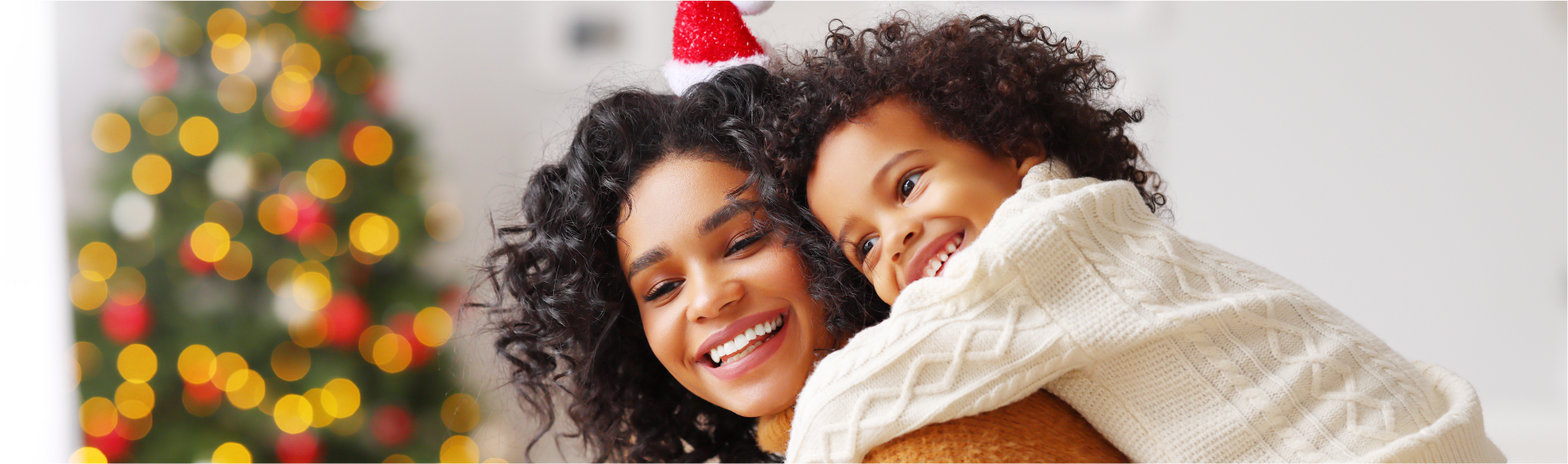 Mother and Daughter in front of Tree with Lights